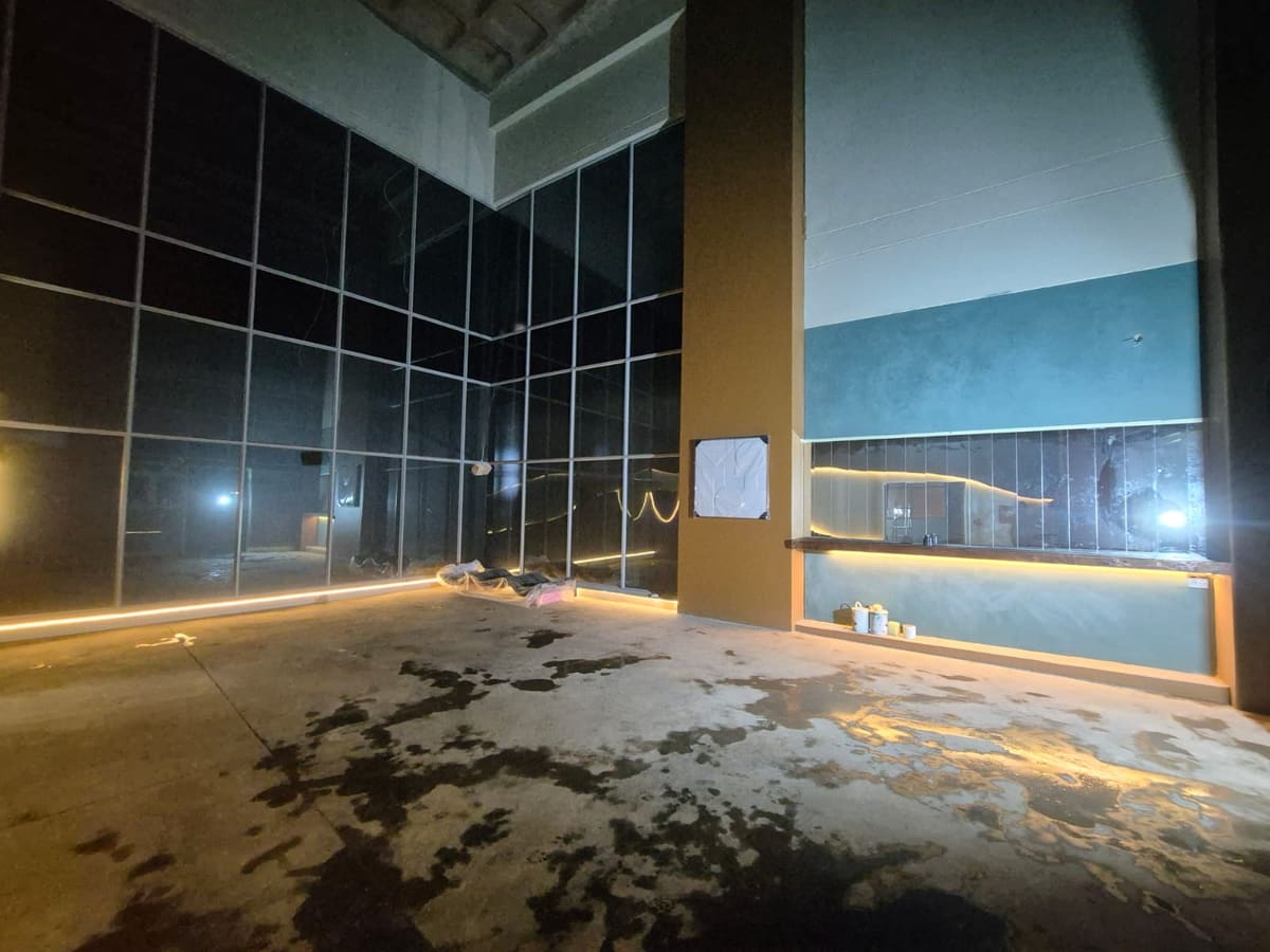 The interior before fit-out, glazing installed and the floor still raw.